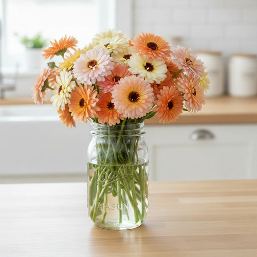 Calendula Cantaloupe Mix apricot peach cream and blush double blooms in a vase on a bright kitchen bench
