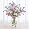 Statice Soft Pastels Mix in a clear glass vase beside a bright window
